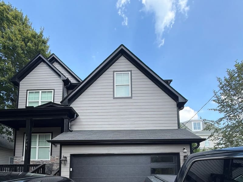 Dark modern sectional garage door on a two-story home in metro Atlanta