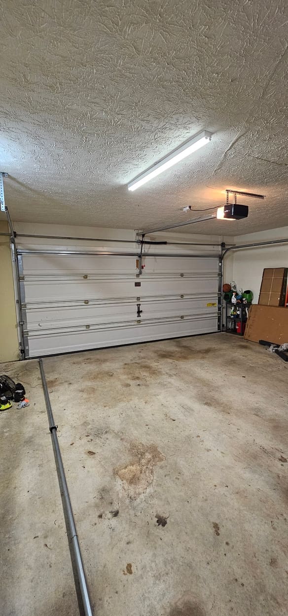 Two-car garage door closed after a broken spring was replaced