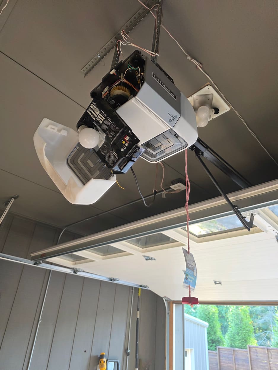 Garage door opener with its cover off during a diagnosis