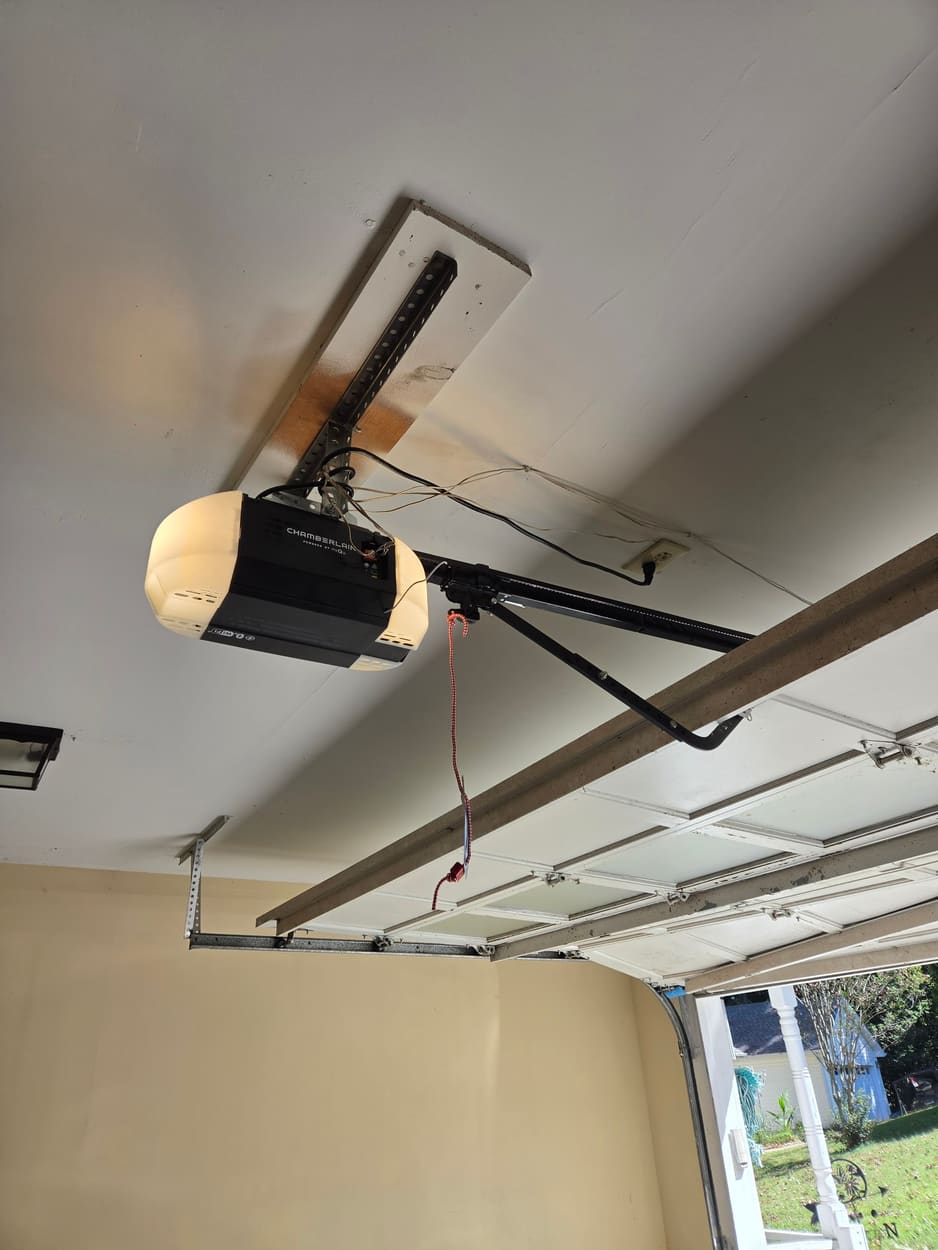 Garage door opener mounted on its ceiling rail