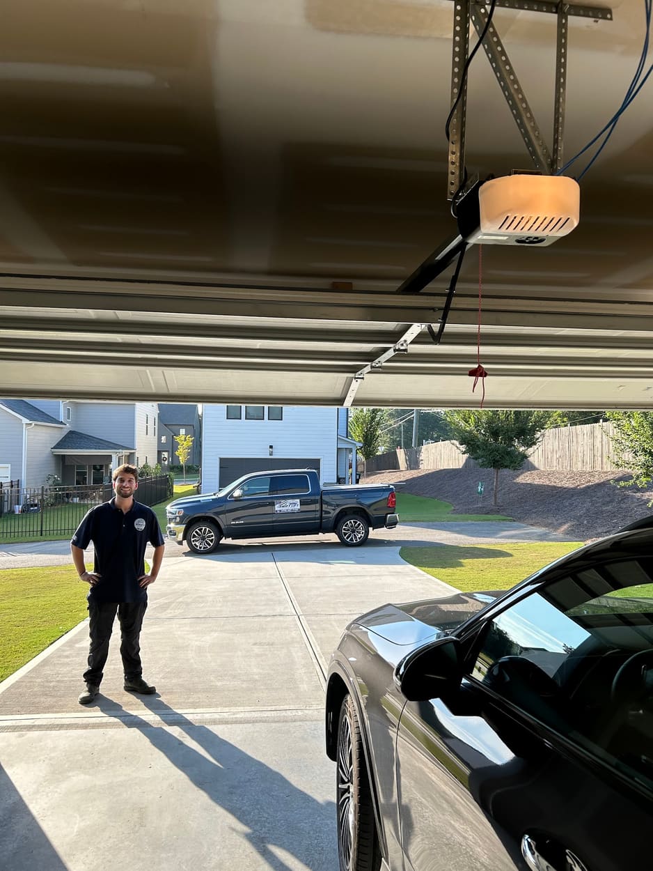 Swift Lift technician standing in a customer's driveway with the company truck behind him